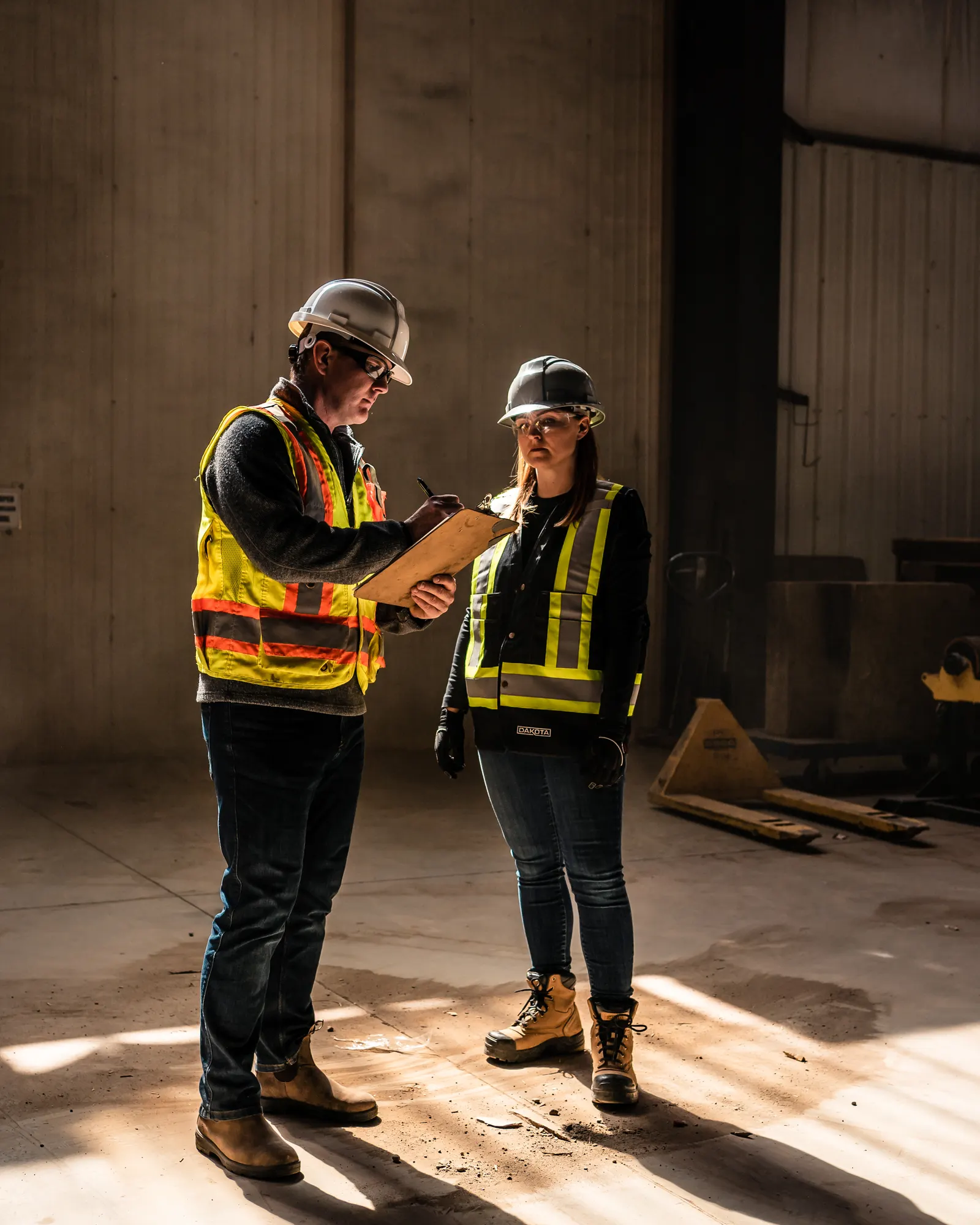 A Canadian safety professional reviewing the portal on a tablet at an active worksite.